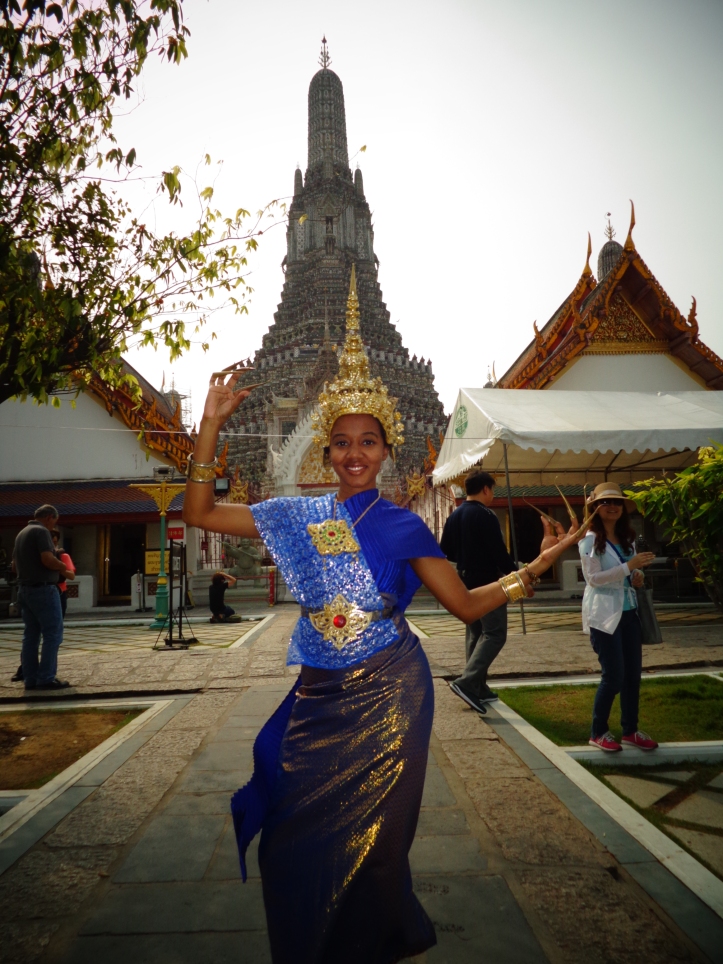 Posing in traditional Thai garb in front of the Temple of Dawn.
